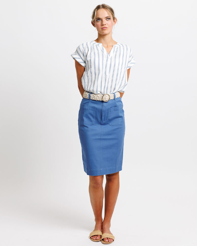 Woman wearing a striped shirt and blue skirt