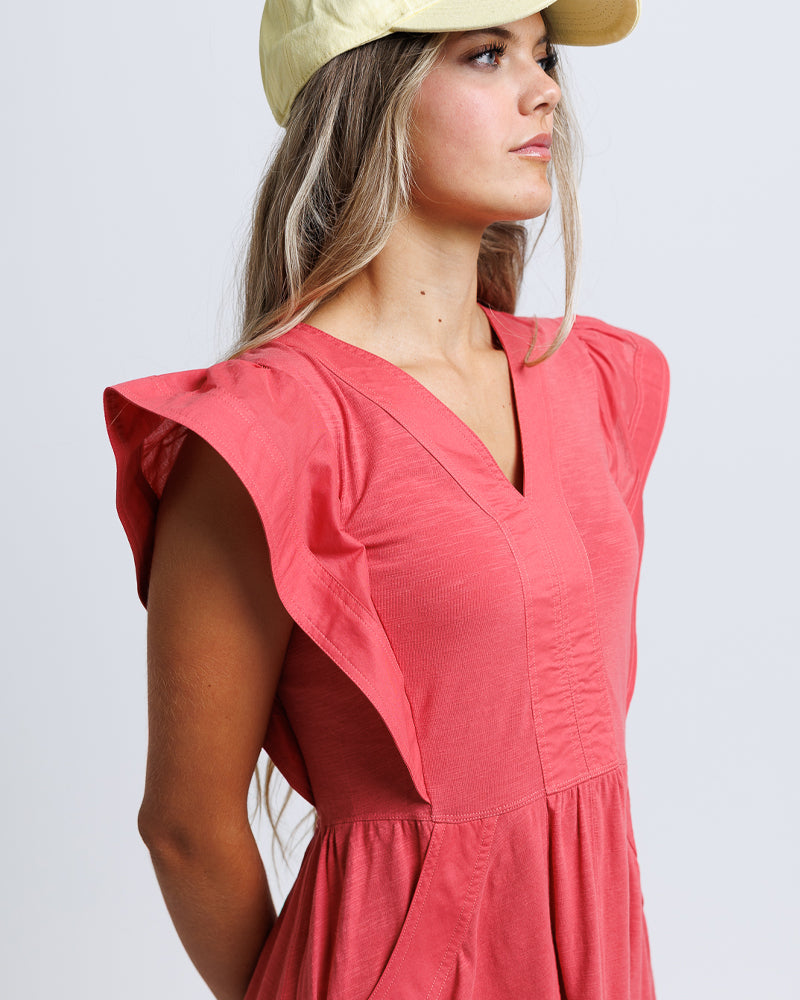 coral dress with ruffled sleeves