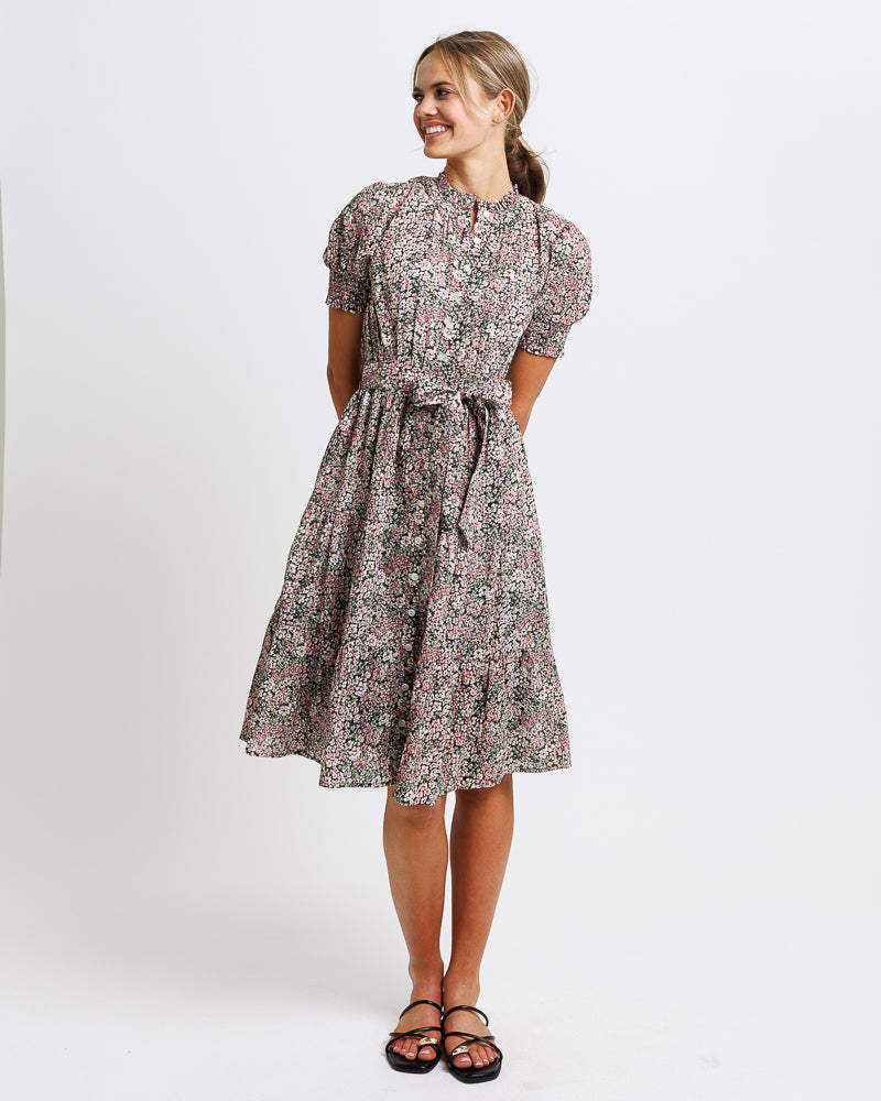 Woman wearing a floral dress on a white background