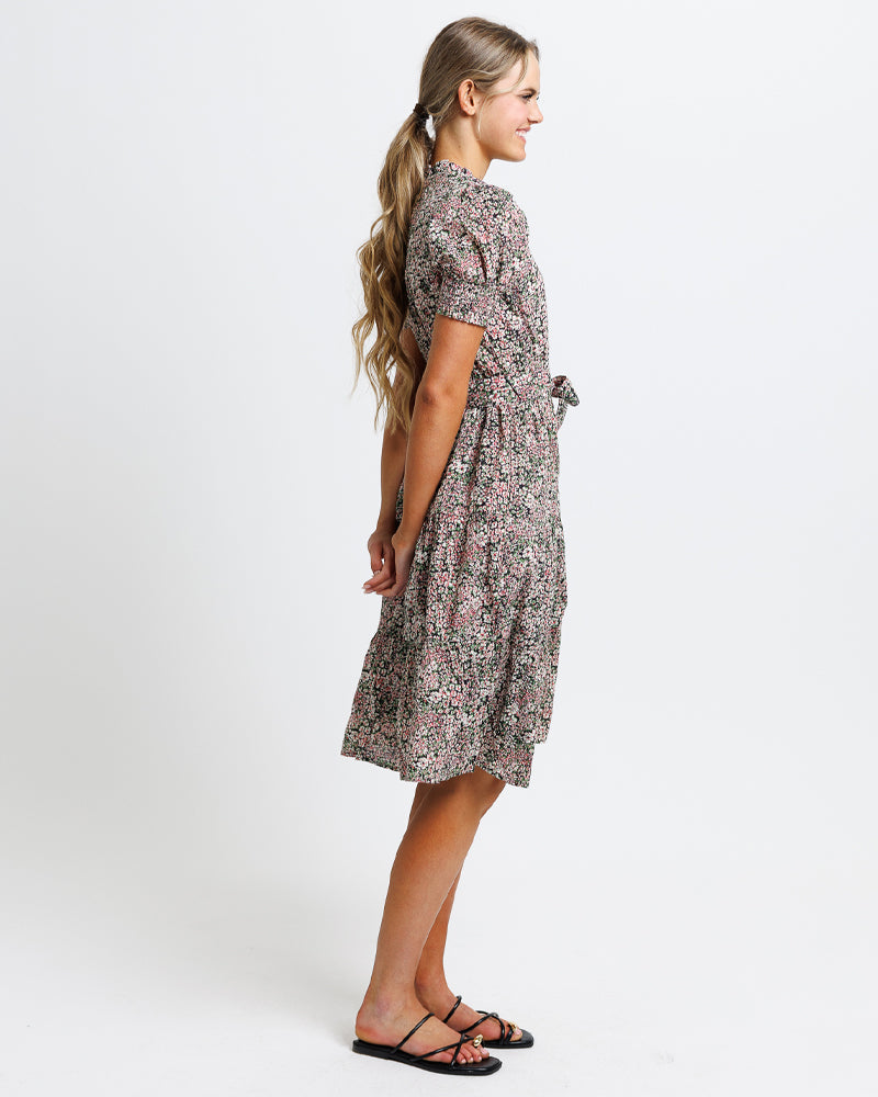 Woman wearing a floral dress on a white background