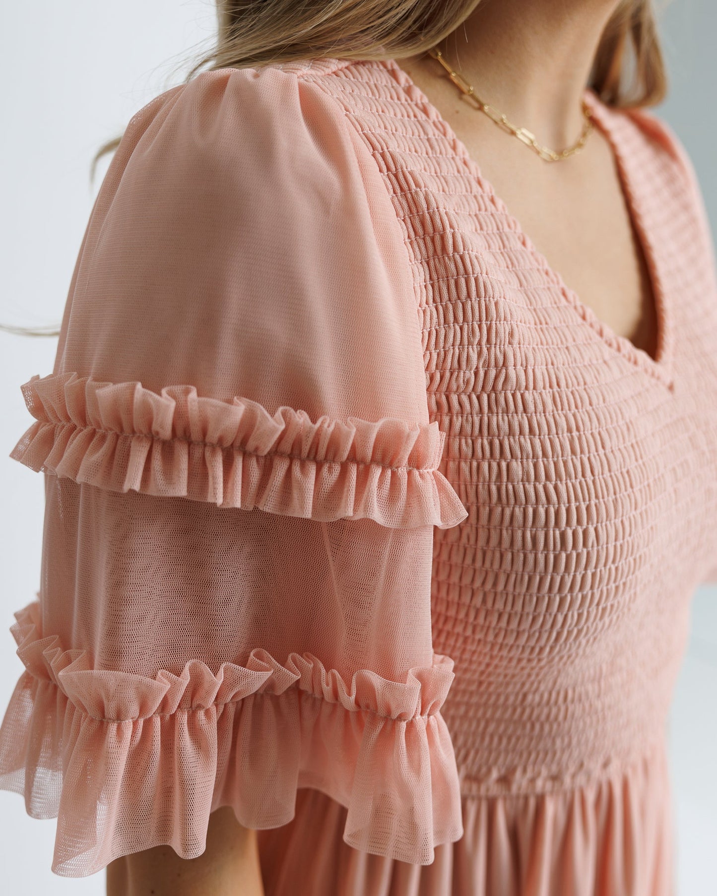Close-up of a pink dress with ruffled details