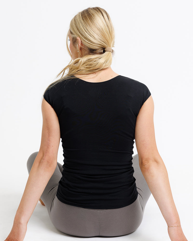 back of a black cotton top on a lady sitting on the floor