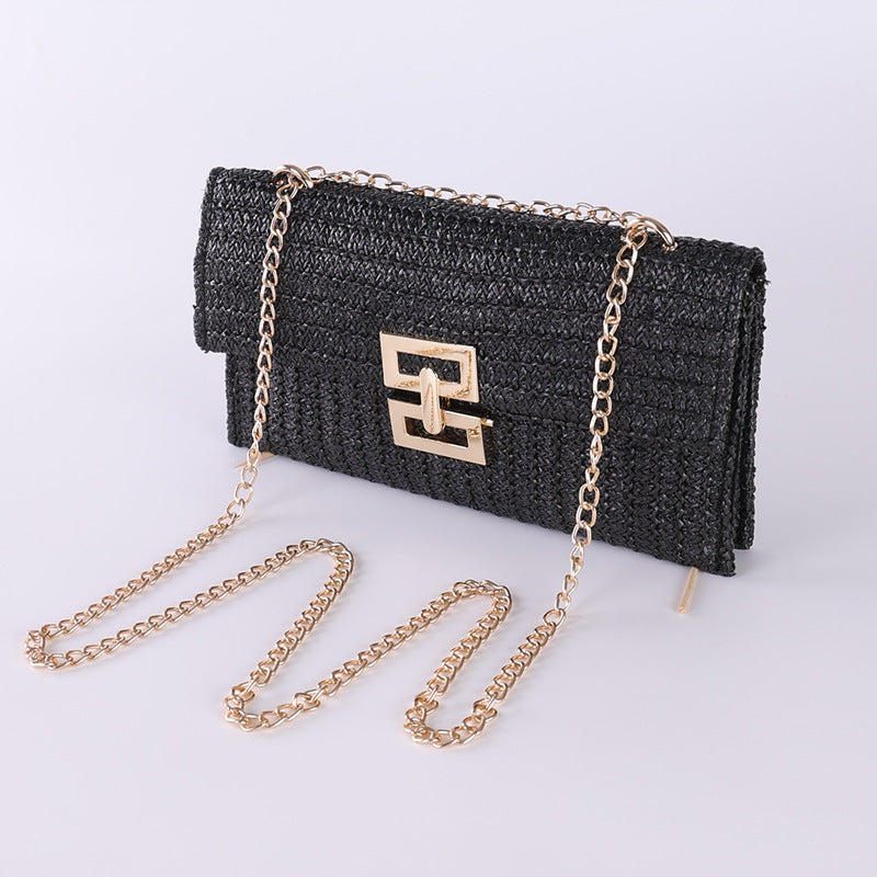 Black textured handbag with gold chain strap