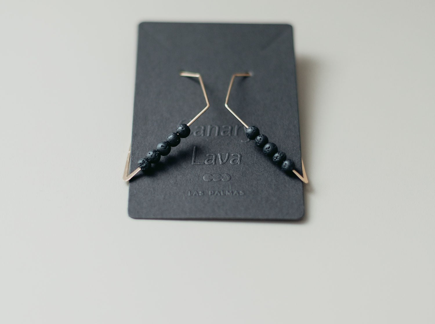Geometric lava stone earrings with gold-plated finish