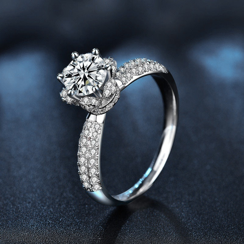 Silver ring with a large diamond and smaller diamonds