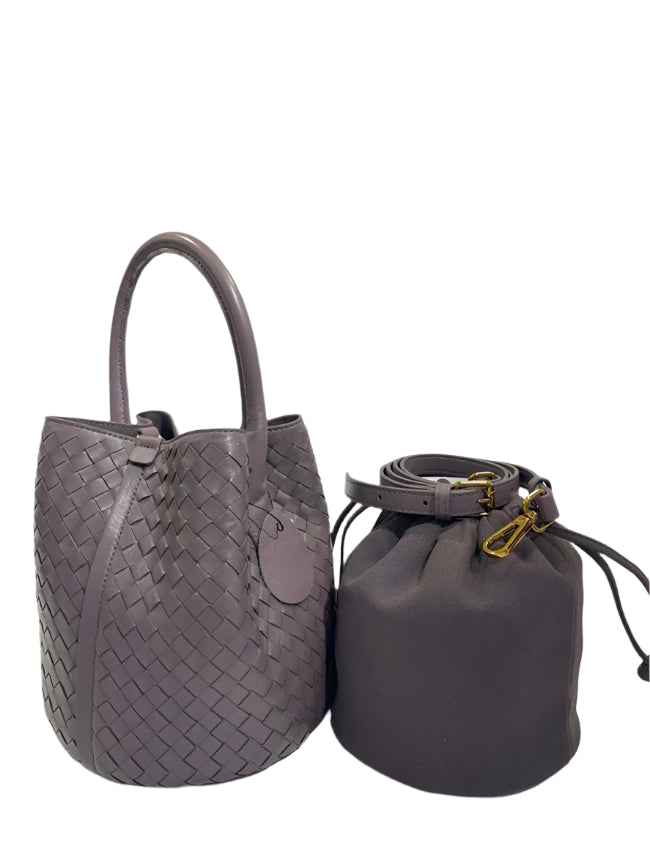 Two purple handbags, one woven and one drawstring,