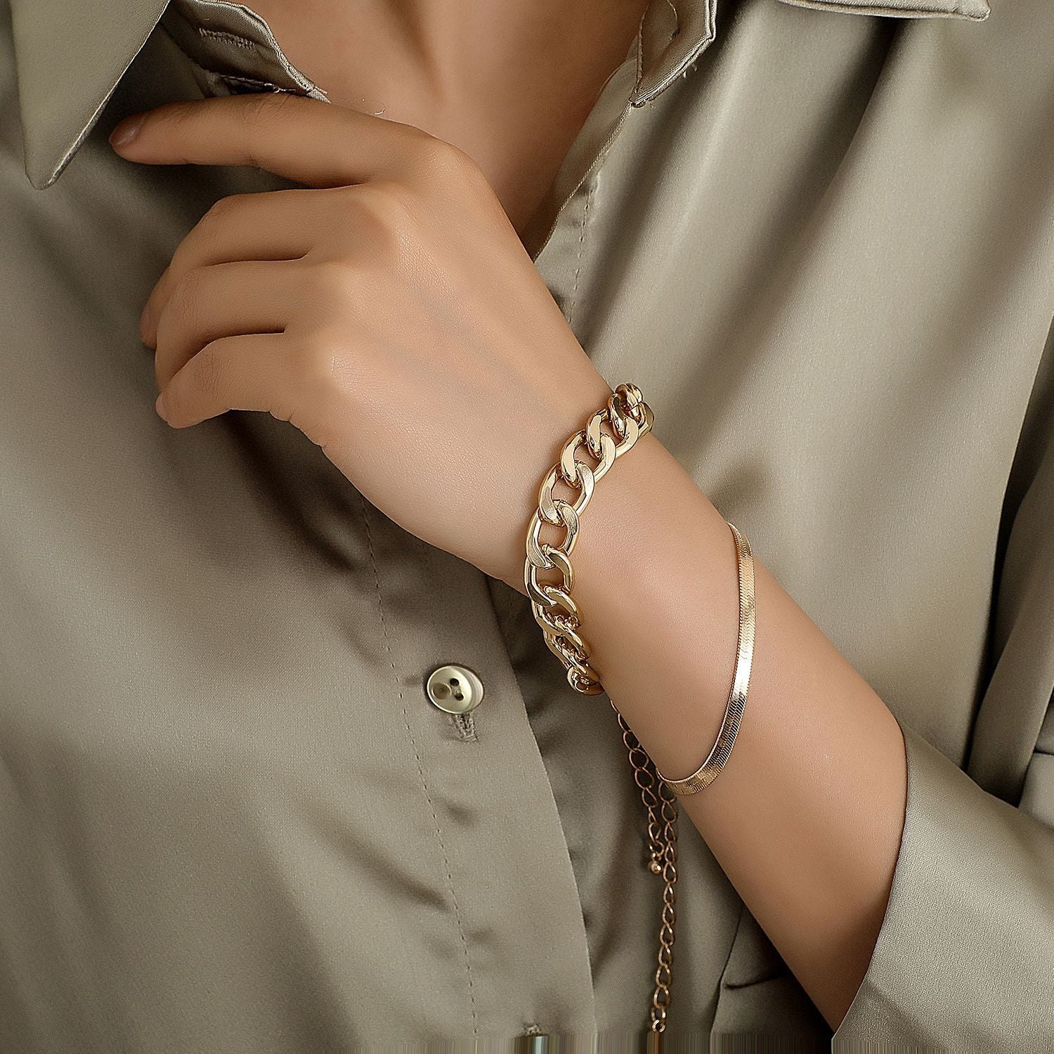 Gold chain bracelet stack on wrist