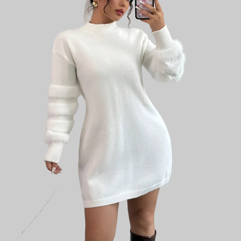 Woman wearing a white sweater dress with fur long sleeves
