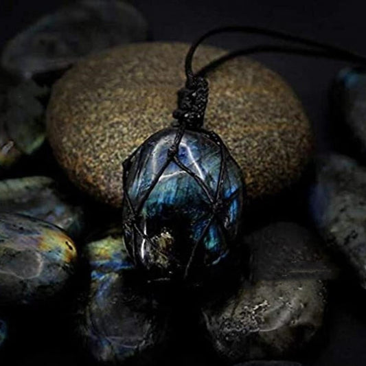 Labradorite stone pendant on a dark background Labradorite stone pendant on a dark background