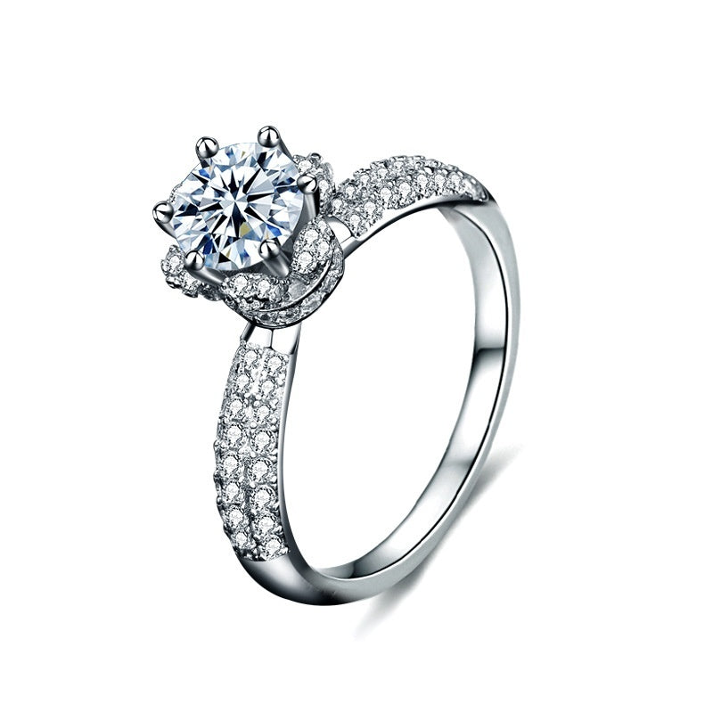 Silver ring with a large central gemstone and smaller stones