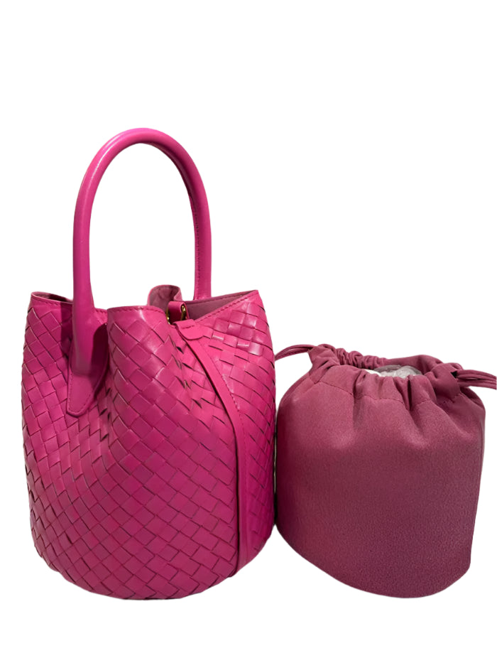 Two pink handbags, one woven and one drawstring.
