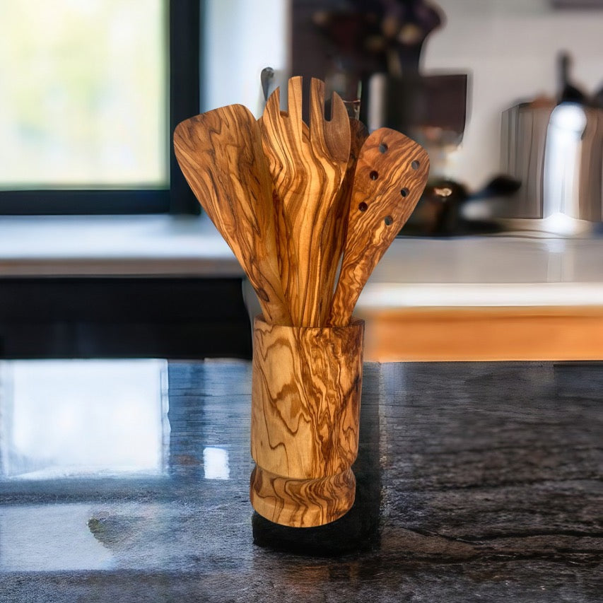 Set of wooden utensils in a holder on a kitchen counter