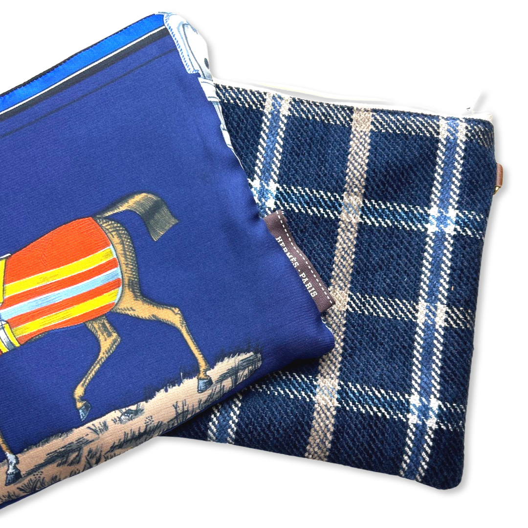 Two pouches, one with a horse design and the other with a plaid pattern, on a white background.