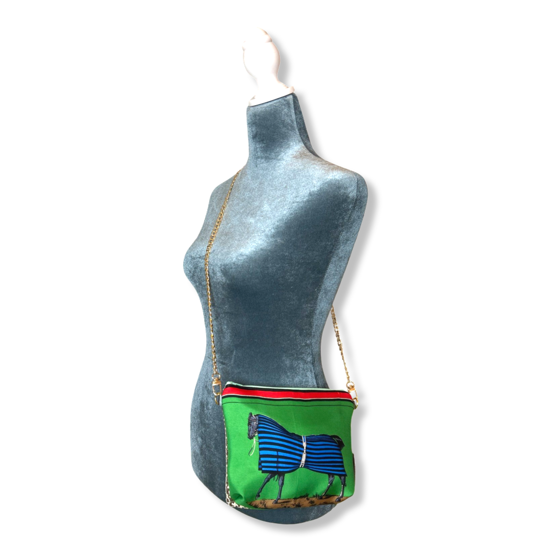 Green bag with horse design on a mannequin against a white background