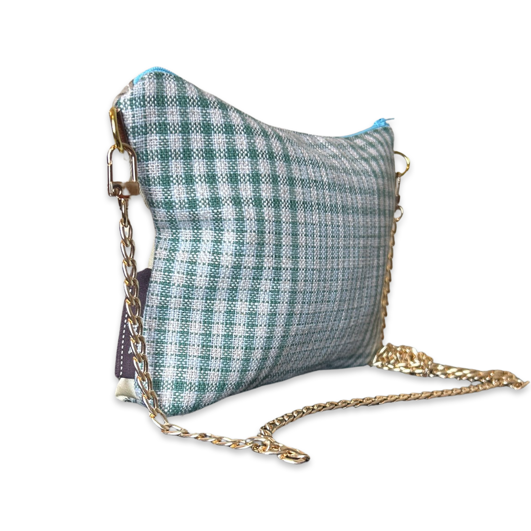 Green and gray checkered bag with a gold chain on a white background