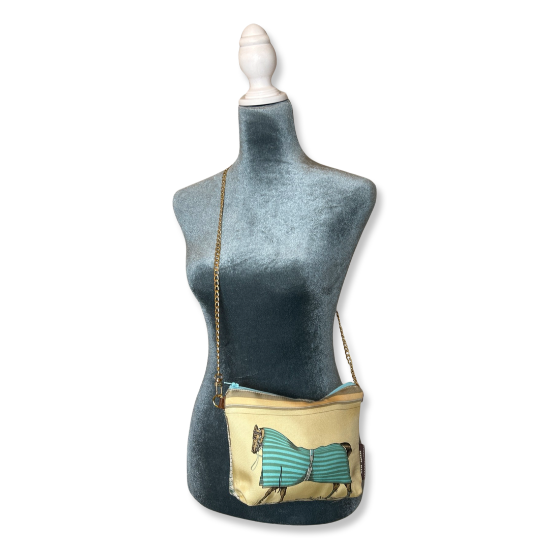 Mannequin wearing a beige handbag with a green bow design on a white background