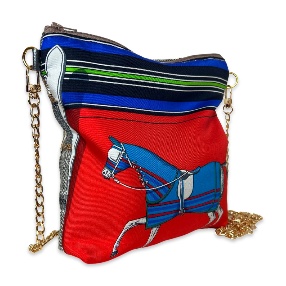 Red bag with horse design and gold chain on a white background