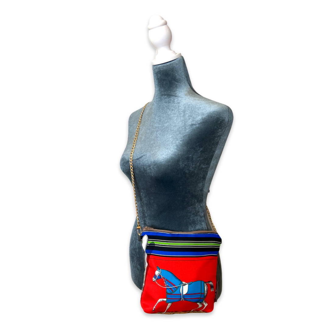 Mannequin wearing a colorful bag with a horse design on a white background