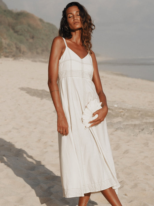 Woman wearing natural Eva Maxi Dress with V-shaped neckline and adjustable straps
 Woman wearing natural Eva Maxi Dress with V-shaped neckline and adjustable straps