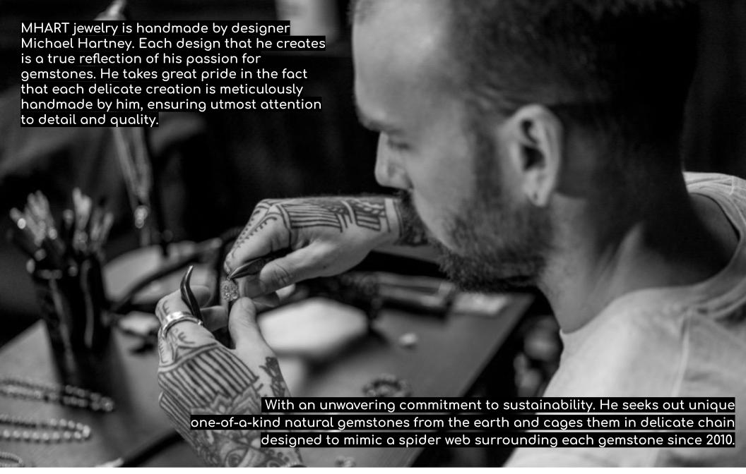 Black and white image of a jewelry maker working on a piece with text about MHART jewelry.