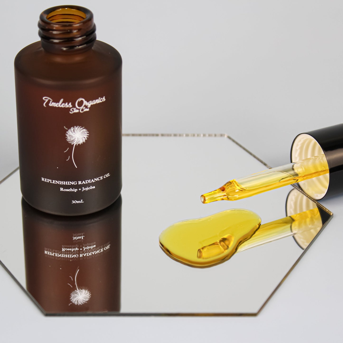 Brown bottle of Timbers Organics replenishing radiance oil with dropper
