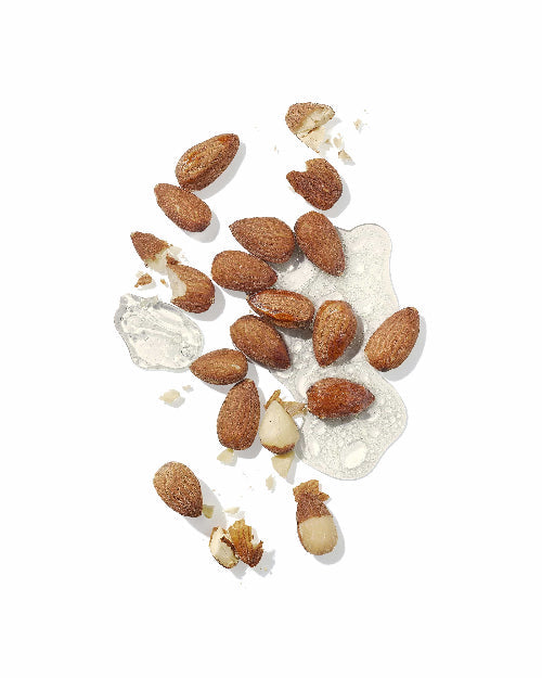 Almonds scattered with a small amount of white powder for Hydrating styling cream
