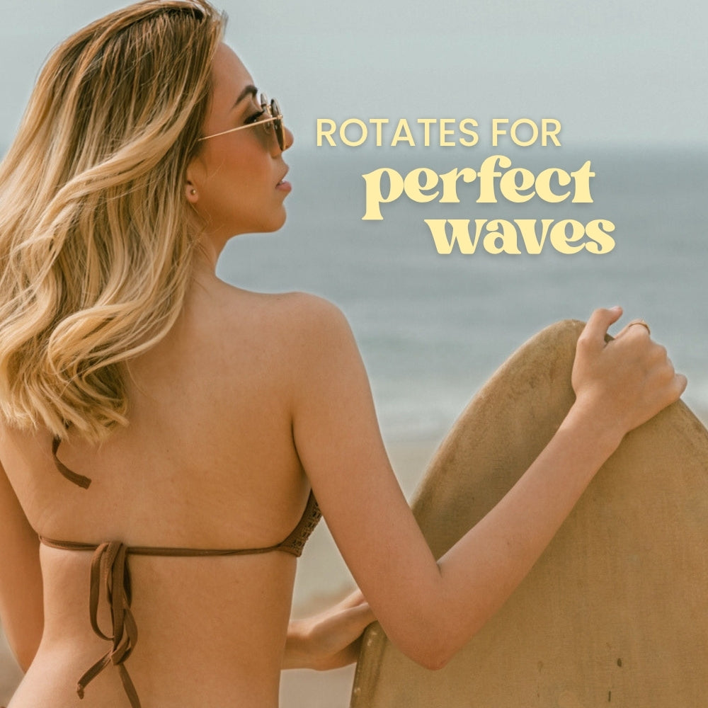 Woman holding a surfboard on a beach with text 'Rotates for perfect waves'.