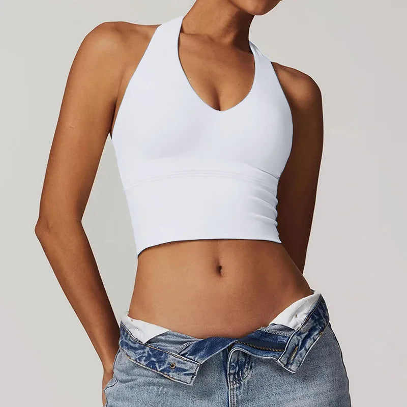 Woman wearing premium white shockproof sports bra during high-intensity workout, showcasing the superior support and push-up design
