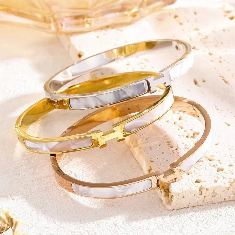 Gold and silver H bangles