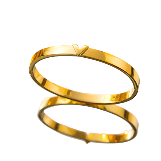 Close‑up of geometric “V” motif engraving on cuff bracelet Close‑up of geometric “V” motif engraving on cuff bracelet