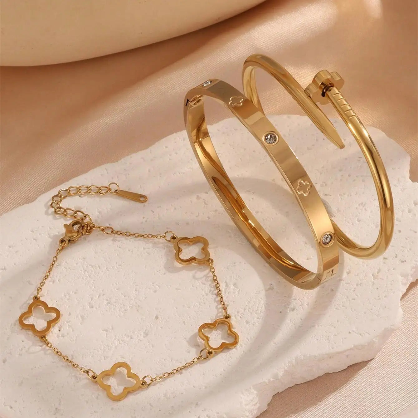 Close‑up of adjustable clover charm on chain bracelet