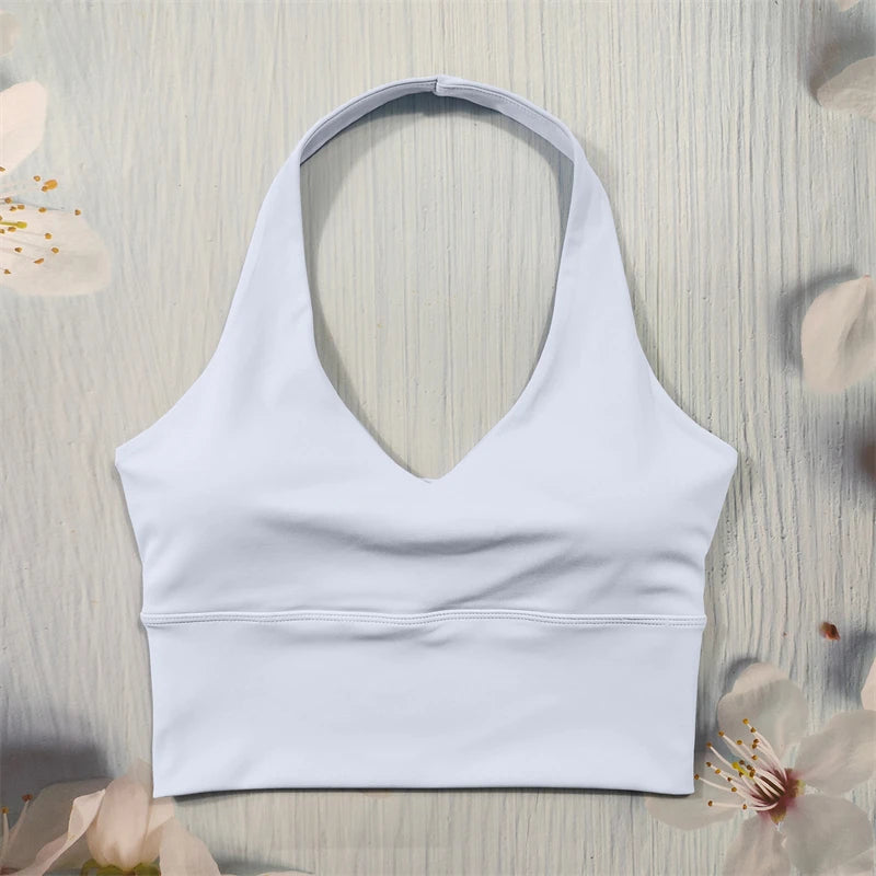 White sports bra on a light wooden surface with floral decorations