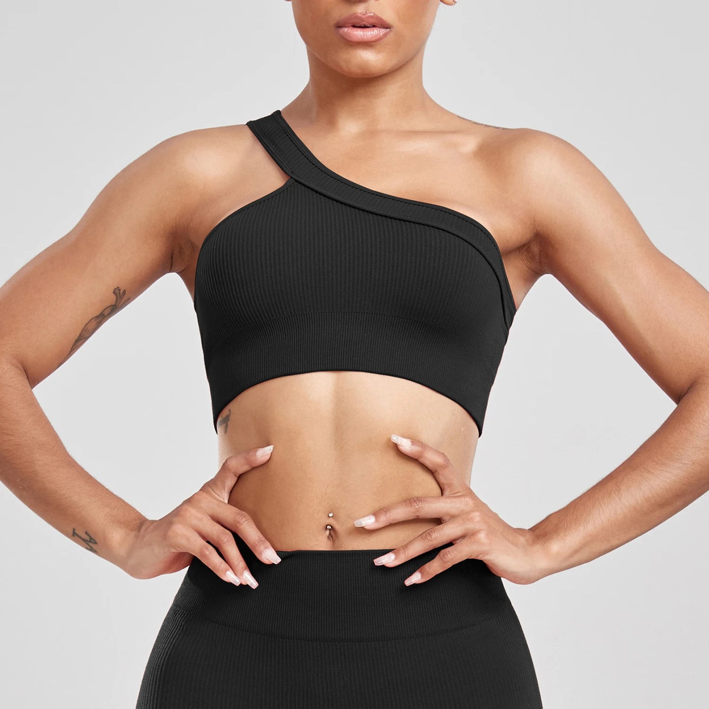 Person wearing a black sports bra and leggings