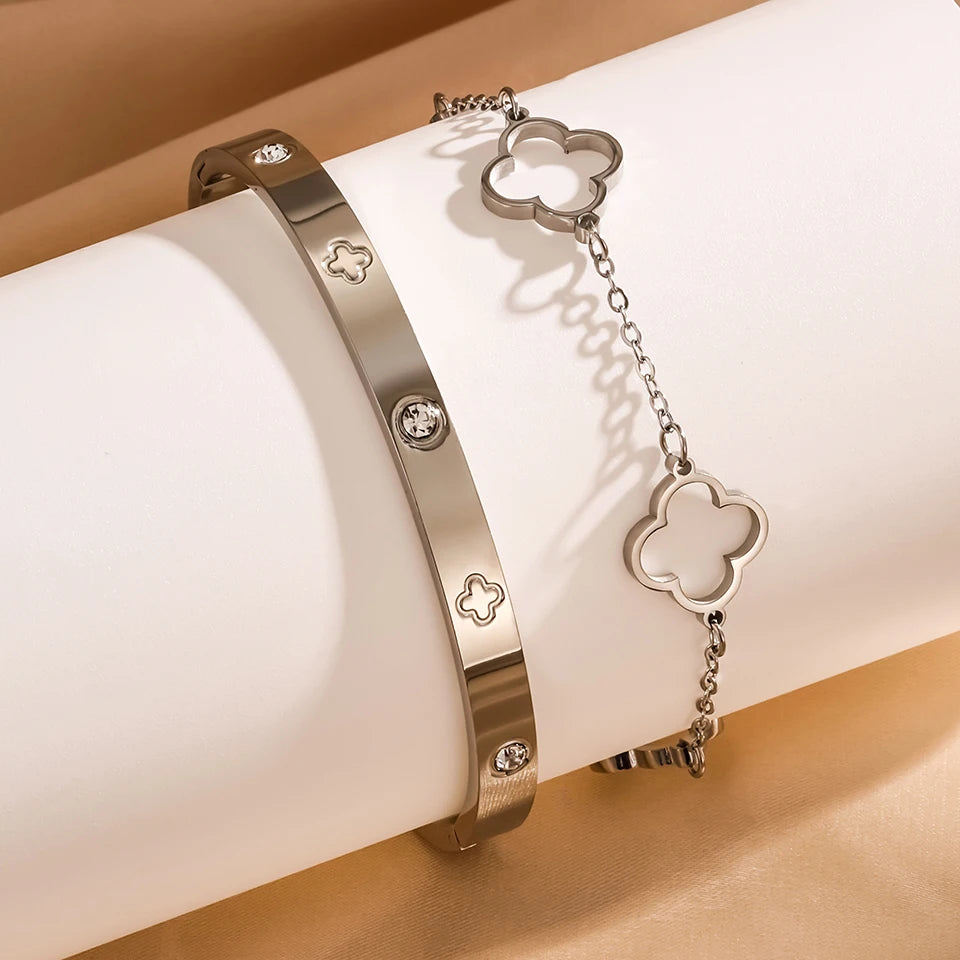 Two silver bracelets with clover-shaped charms