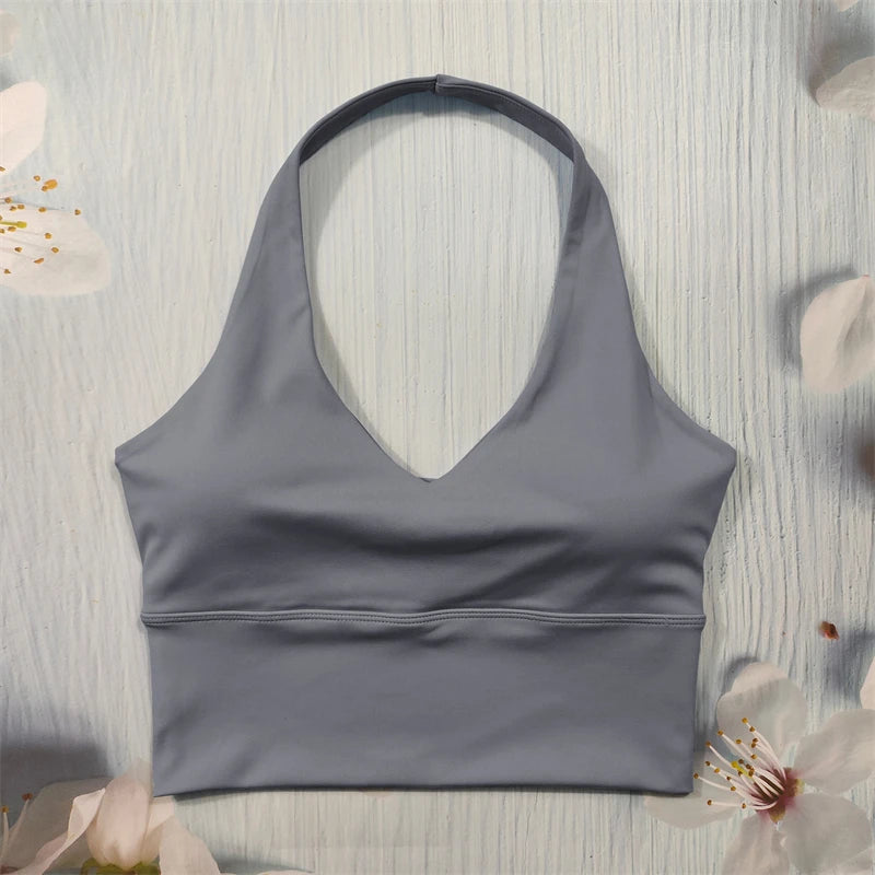 Gray sports bra on a light wooden with floral decorations