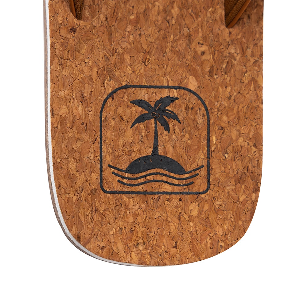 Close-up of a cork sandal with a palm tree and wave design.
