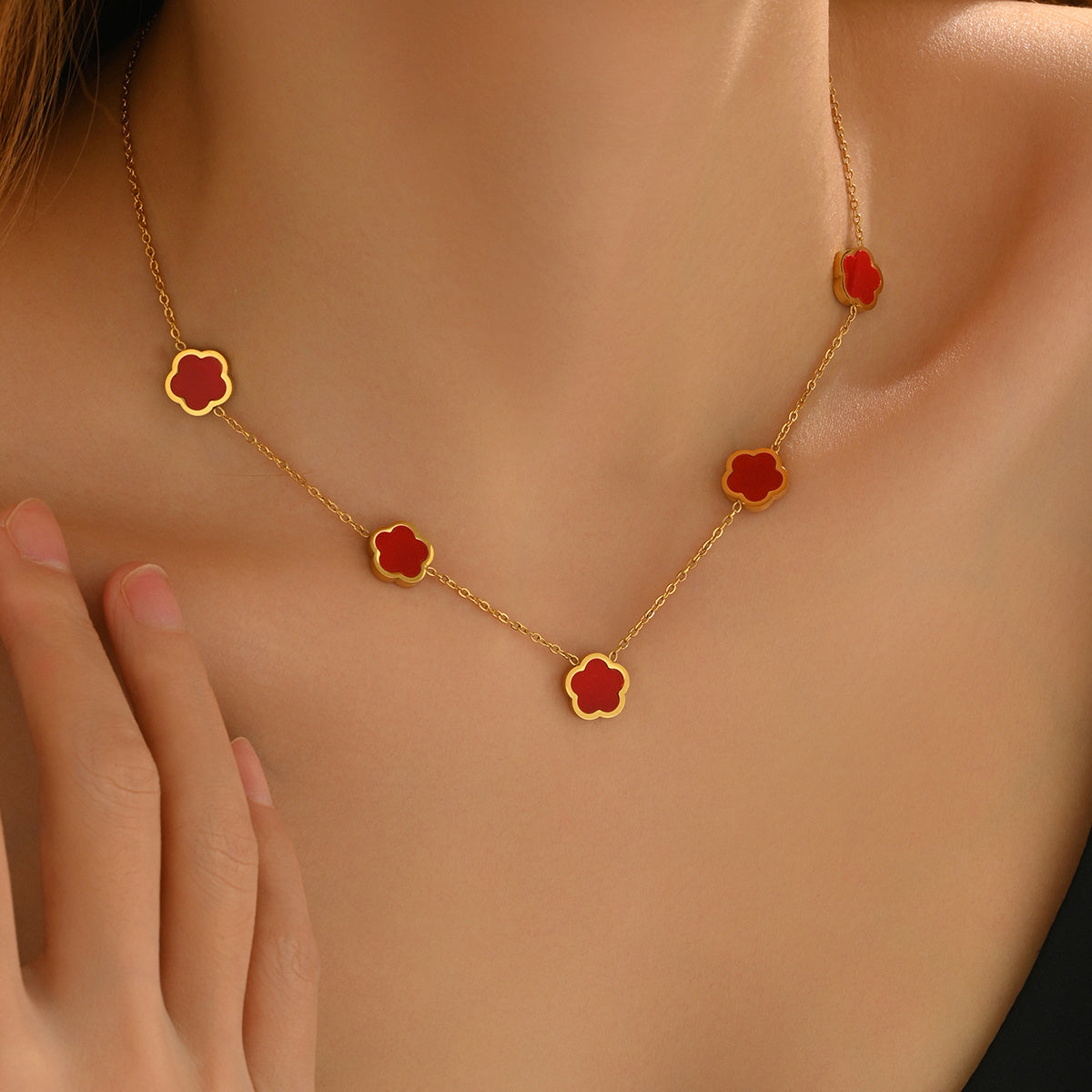 Gold necklace with red flower pendants