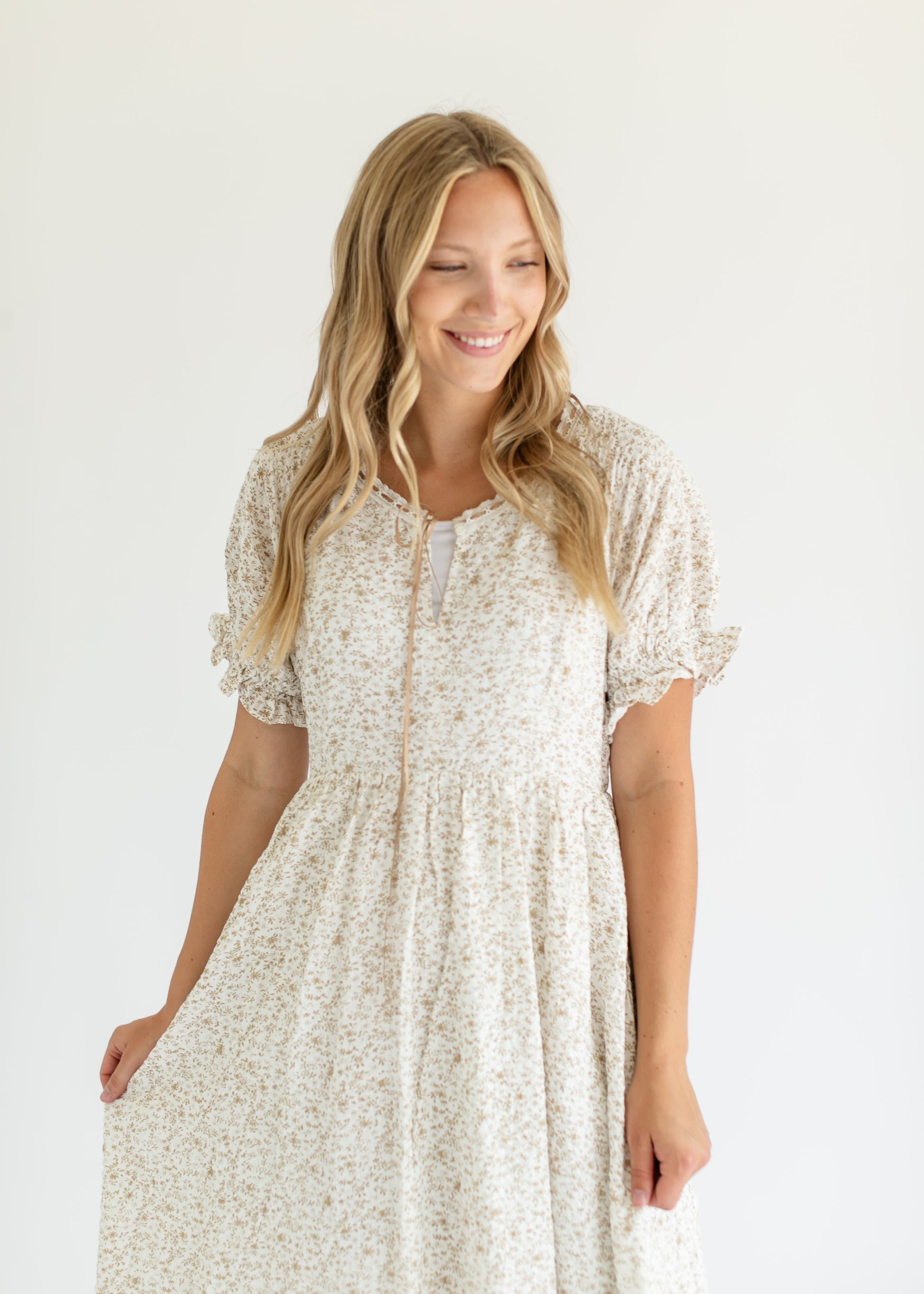 Woman wearing a floral dress on a white background