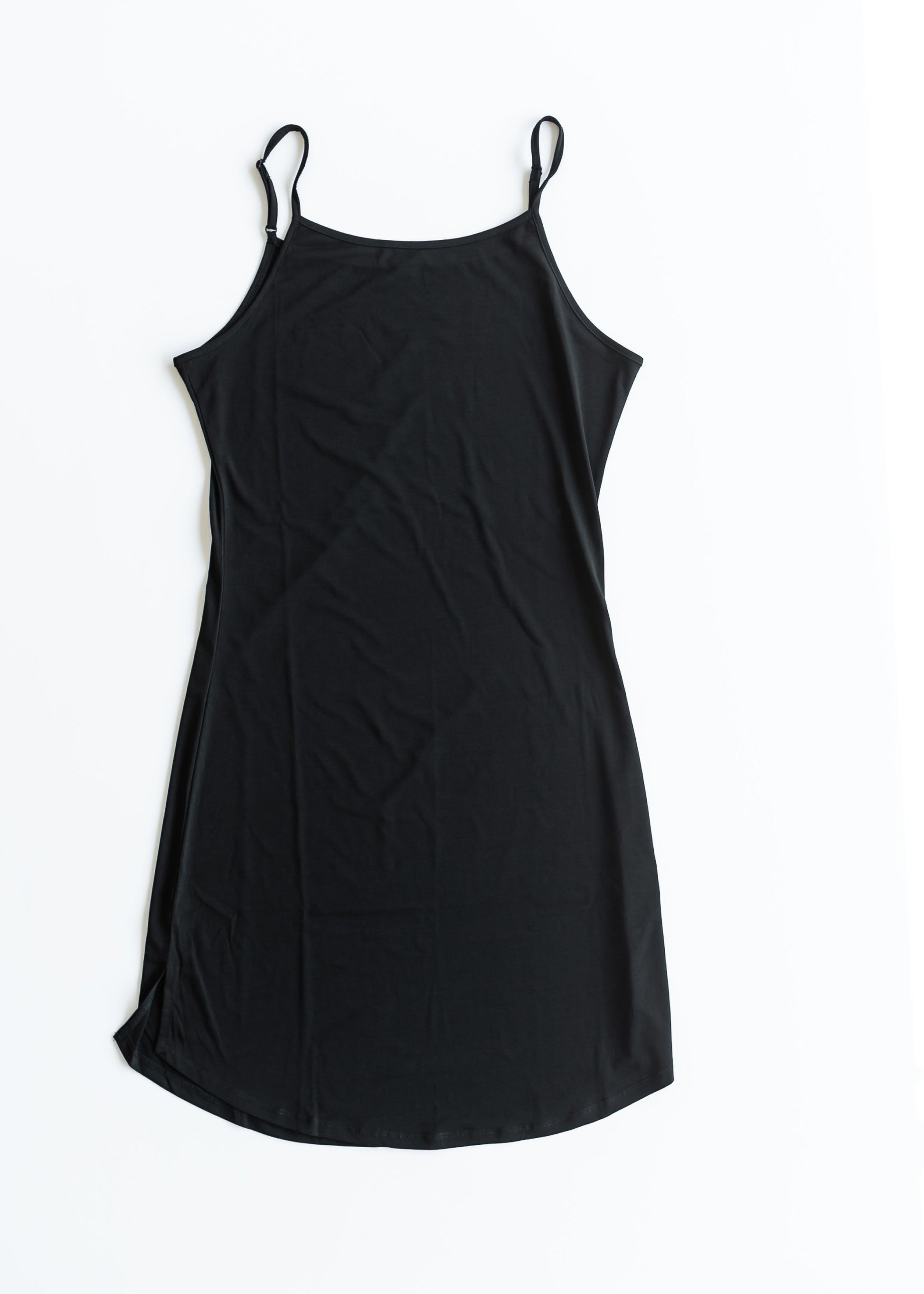 Black slip dress on a white background