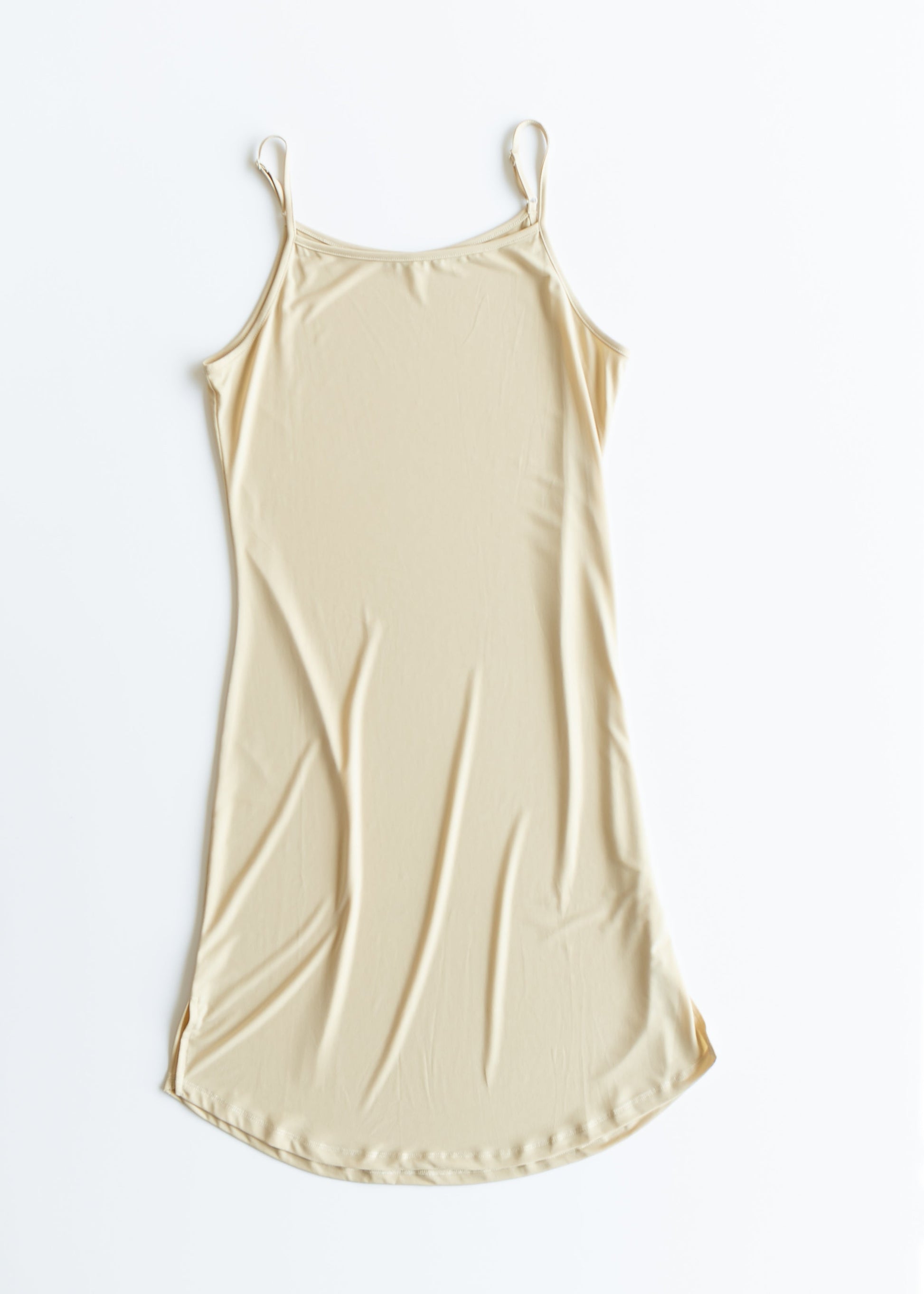 Beige slip dress on a white background