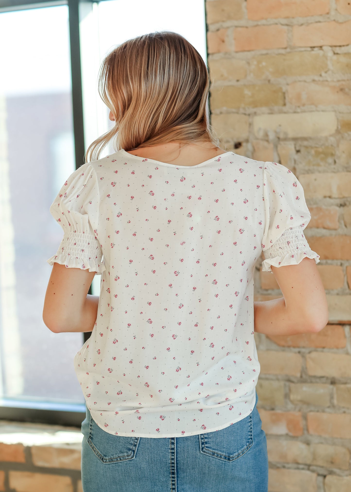 Model wearing Alisa floral top in white  – casual and dressy outfit option