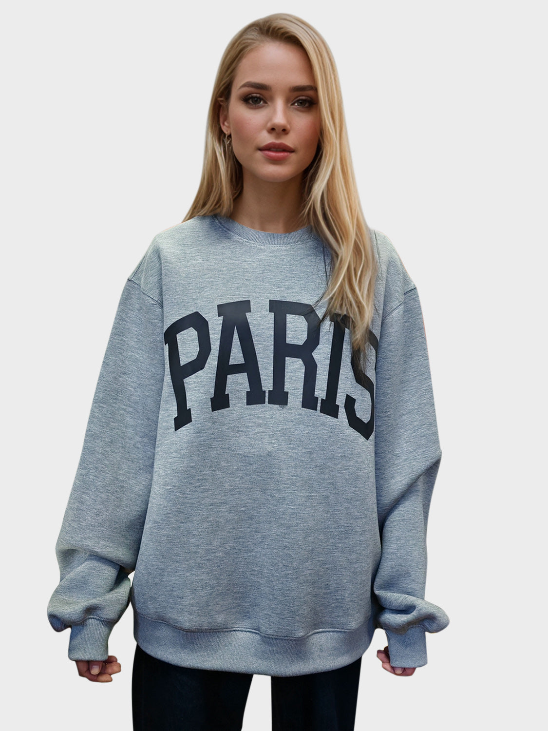 a grey big  sweater  with the name paris