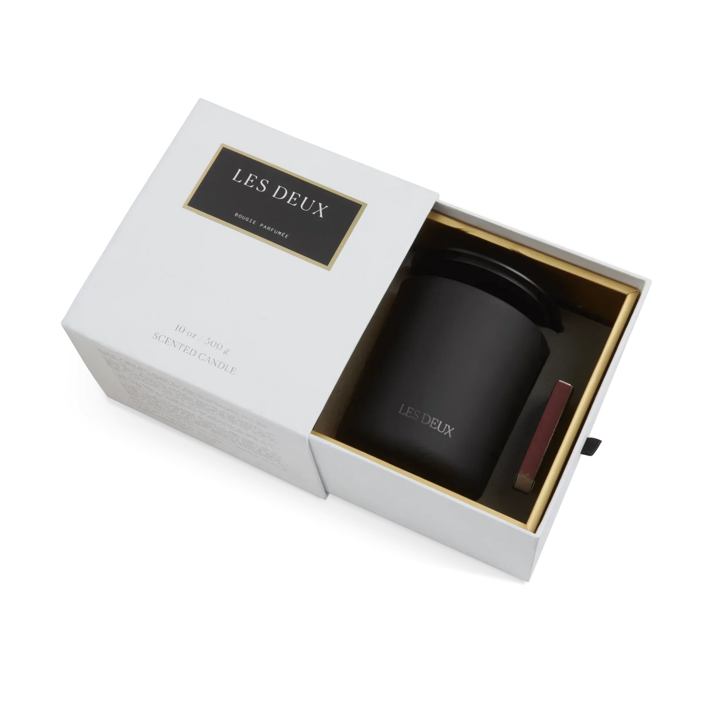 Black candle in a white box with 'LES DEUX' branding