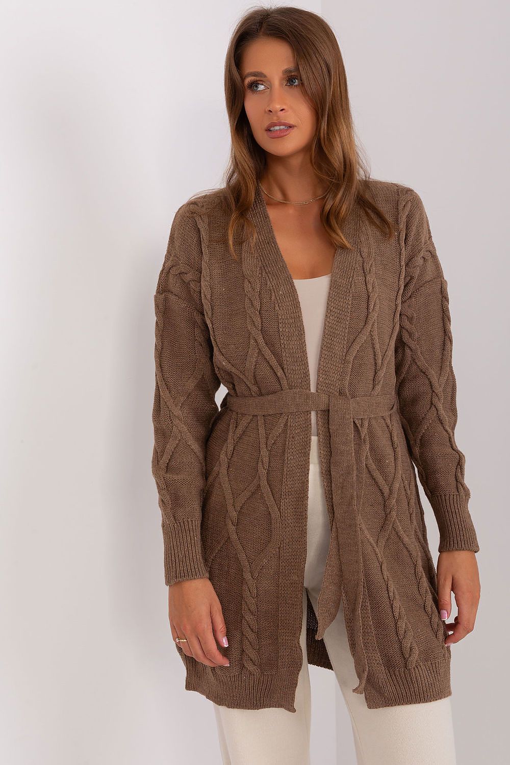 Woman wearing a brown plaid belted cardigan