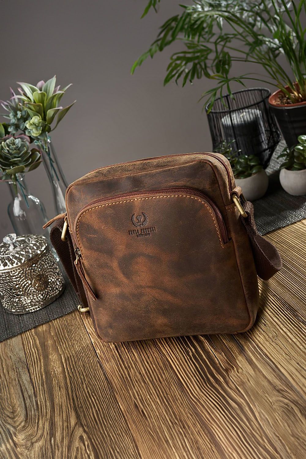All  leather bag  on a wood table