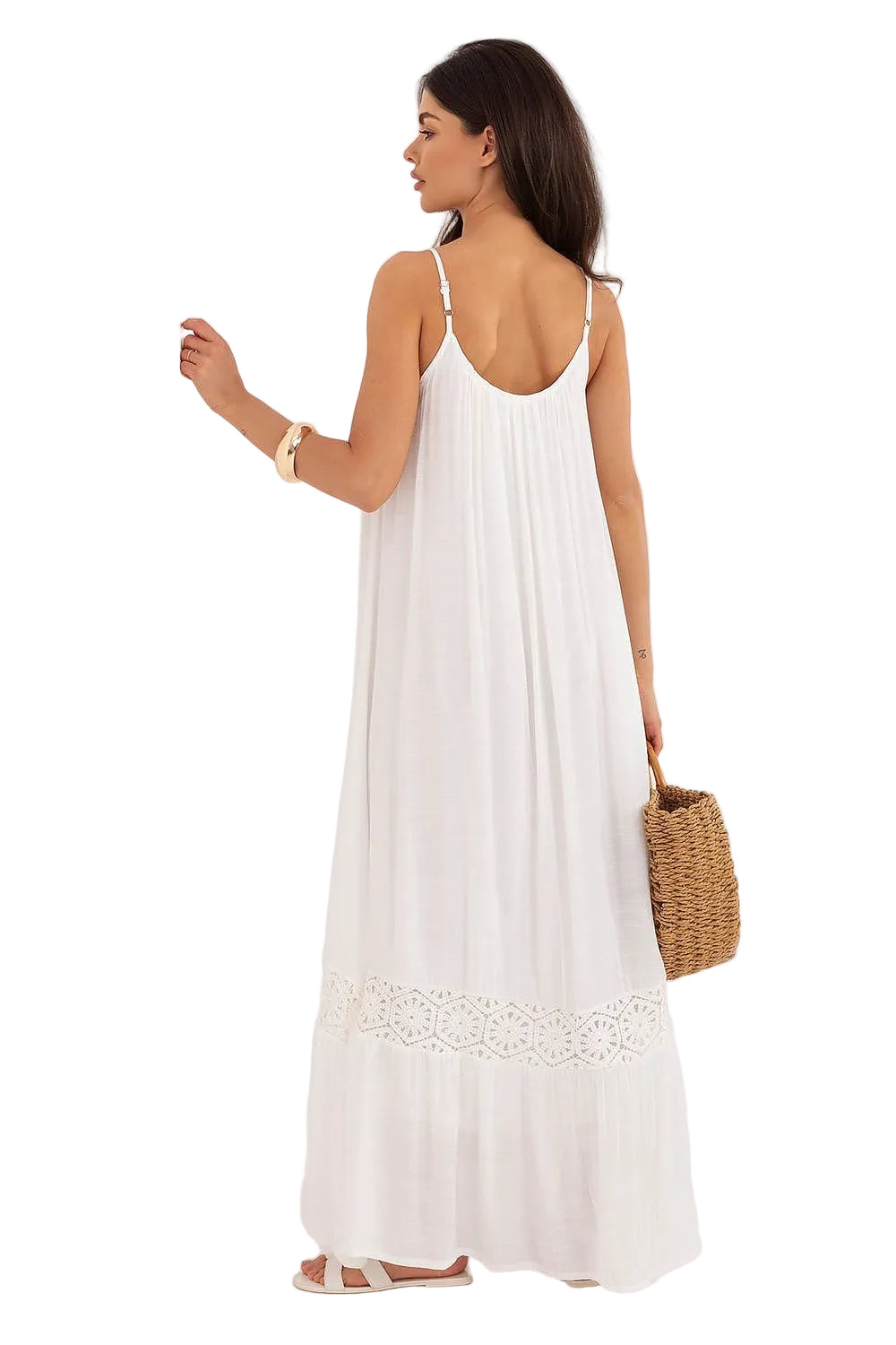 Back view of a model in a white maxi sun dress, highlighting the airy, tiered fabric drape and floor-length hemline.
