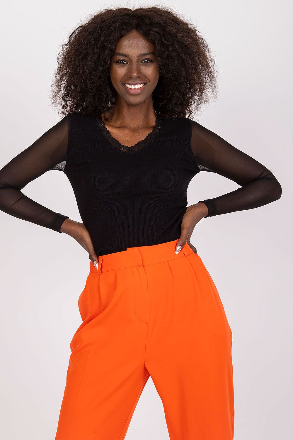 Woman wearing ruched wrap black  blouse with heart neckline detail