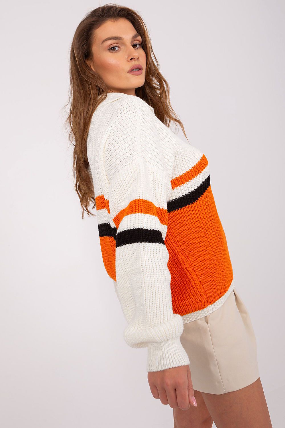 Fashionable woman wearing a fitted Badu sweater with subtle stripes