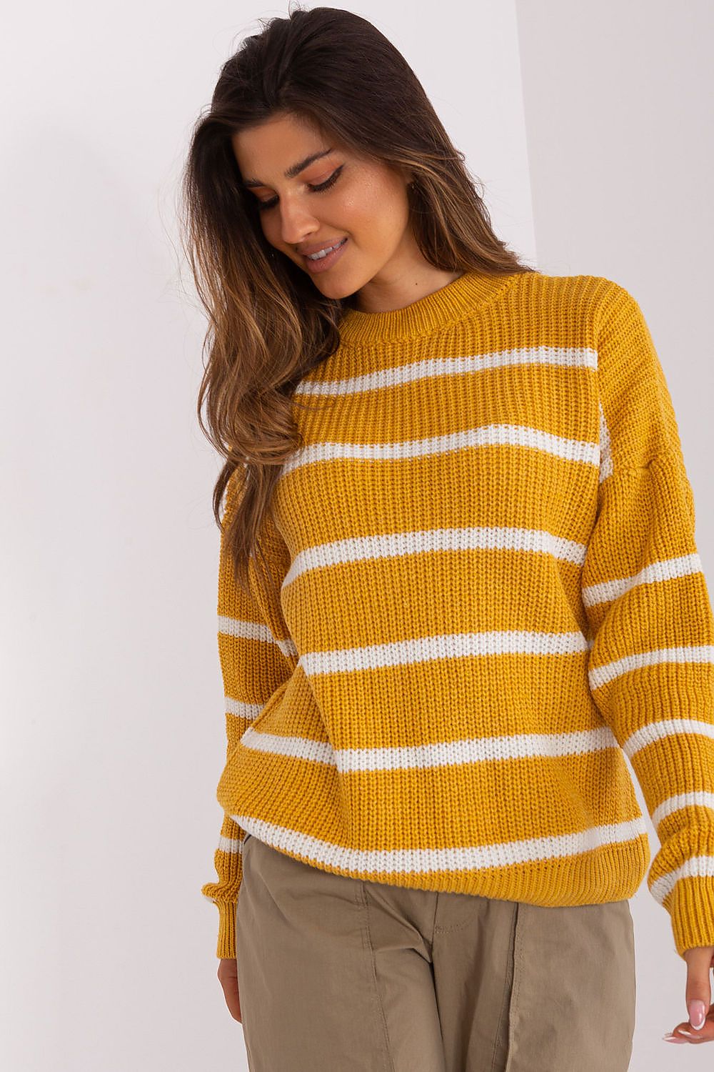 Model in comfortable yellow and white striped pullover