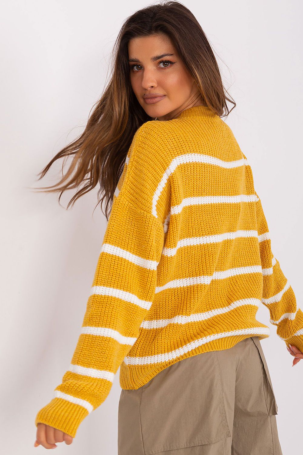 Stylish striped sweater paired with casual trousers
